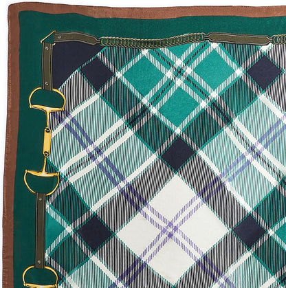 Green, blue, and white plaid silk scarf with a brown border and gold-tone horse bit designs on the left edge. Available sizes: 20″x20″, 36″x36″.