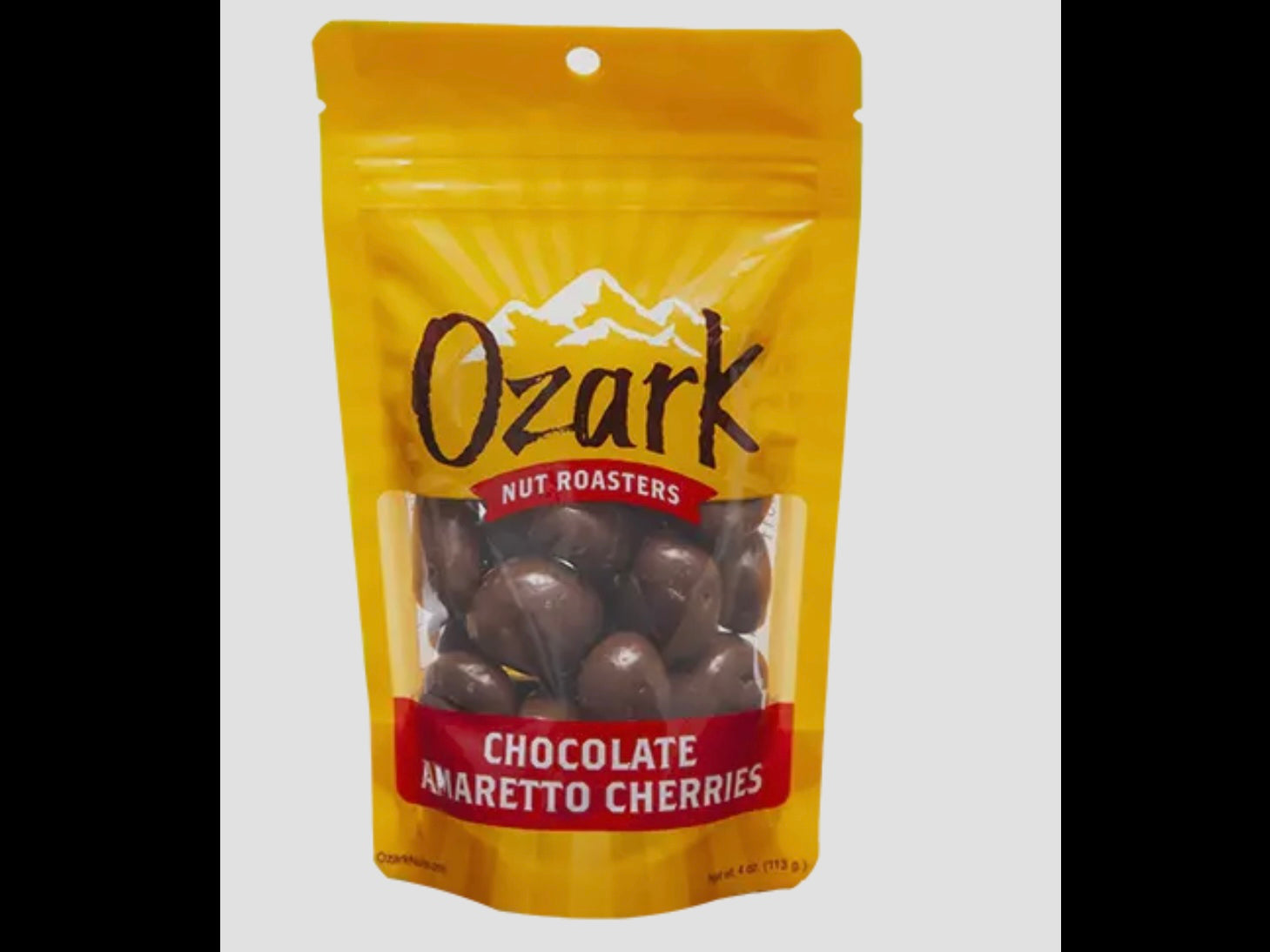 Yellow resealable 3.5oz Ozark Nut Roasters bag with clear window showing milk chocolate-covered cherries inside.