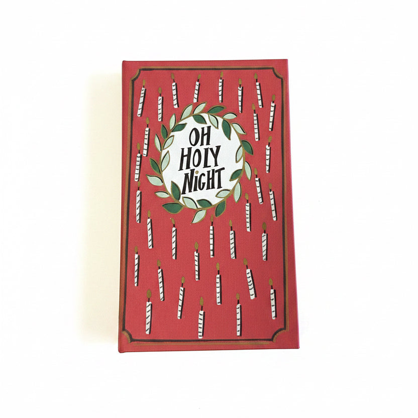 Red rectangular canvas book storage box with a candle pattern and “Oh Holy Night” wreath.