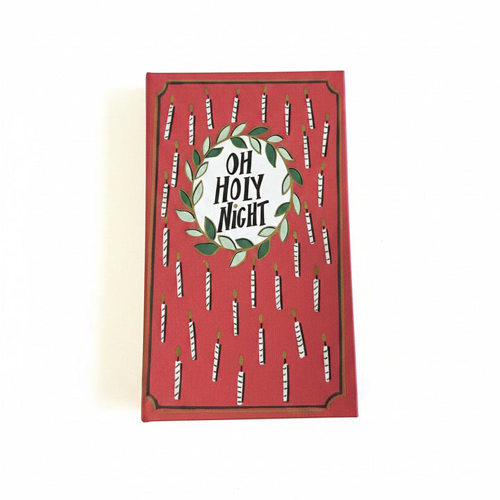 Red rectangular canvas book storage box with a candle pattern and “Oh Holy Night” wreath.