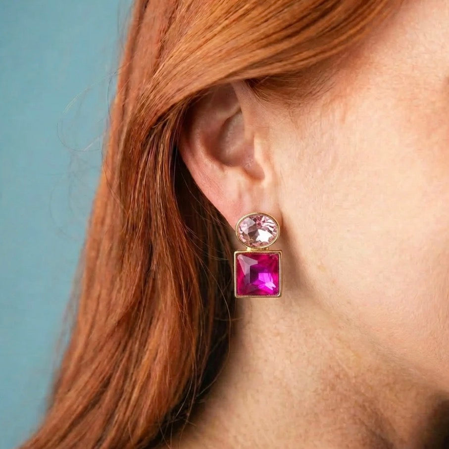 Stacked Gem Earrings: dangling design with a round light pink gem above a large square magenta gemstone in gold. Available in small, medium, and large sizes.