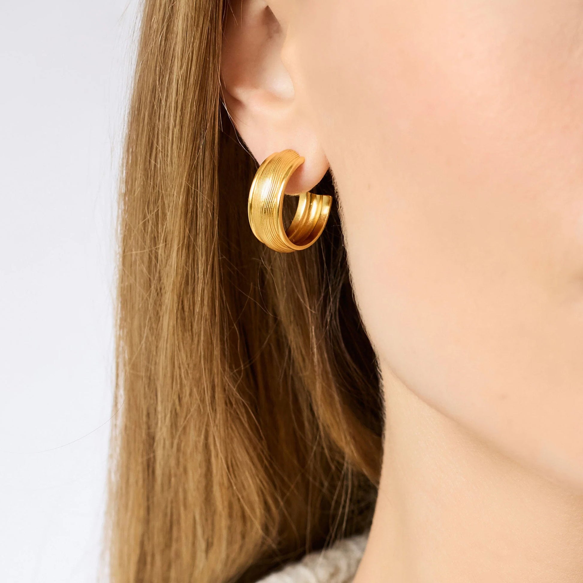 Shiny, textured 24K gold plated Cobblestone Hoop earring by Julie Vos in medium size; also available in other sizes.