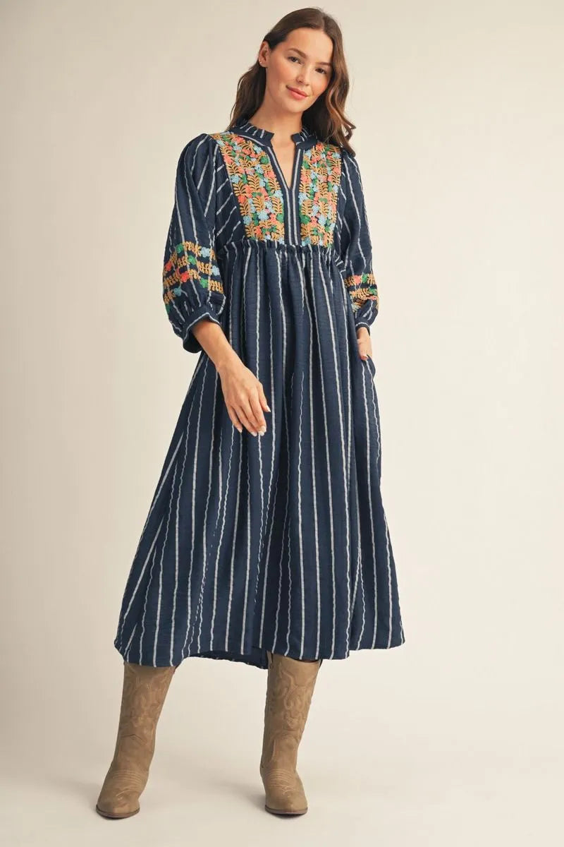 Navy blue Floral Embroidered Midi Dress with long sleeves and colorful floral embroidery; available in sizes XS-XL.