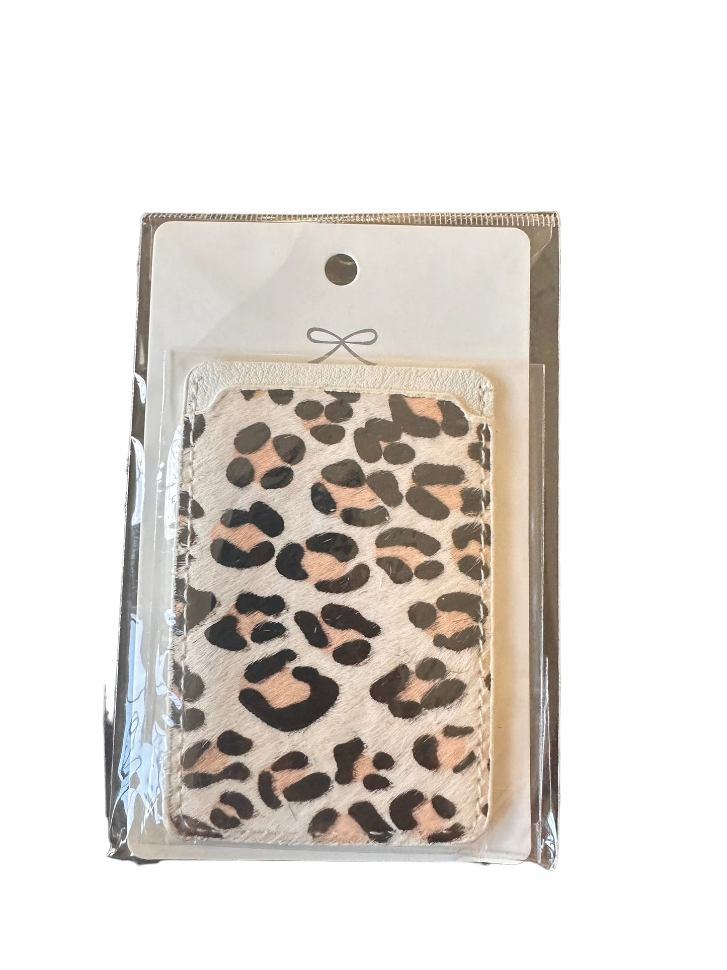 Phone Card Holder with black and light brown leopard spots on a white background. Packaging: clear plastic with white and silver backing card featuring a silver bow design.

Sizes available:
- One size fits most phones.