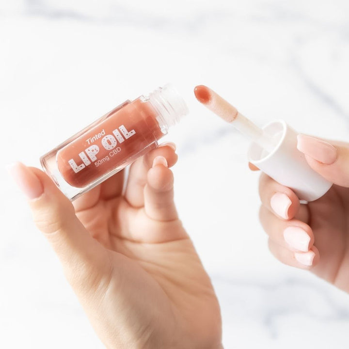 Tinted Lip Oil with applicator wand; available in 5ml and 10ml sizes.