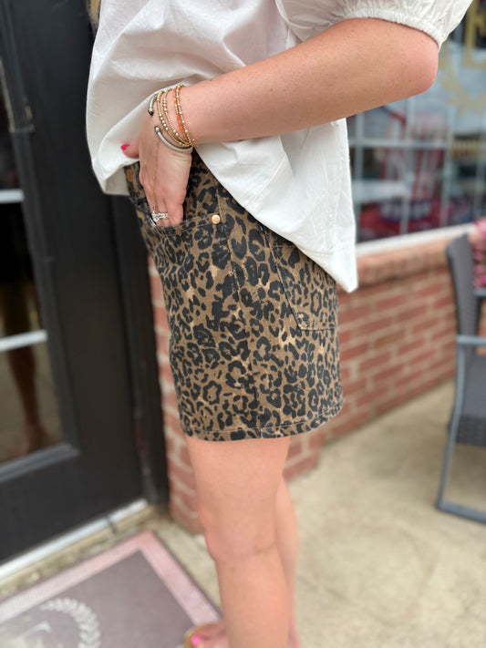 Judy Blue HW Cut Off Leopard Print Shorts; available in sizes S-XL. Distressed hem, bold leopard pattern.