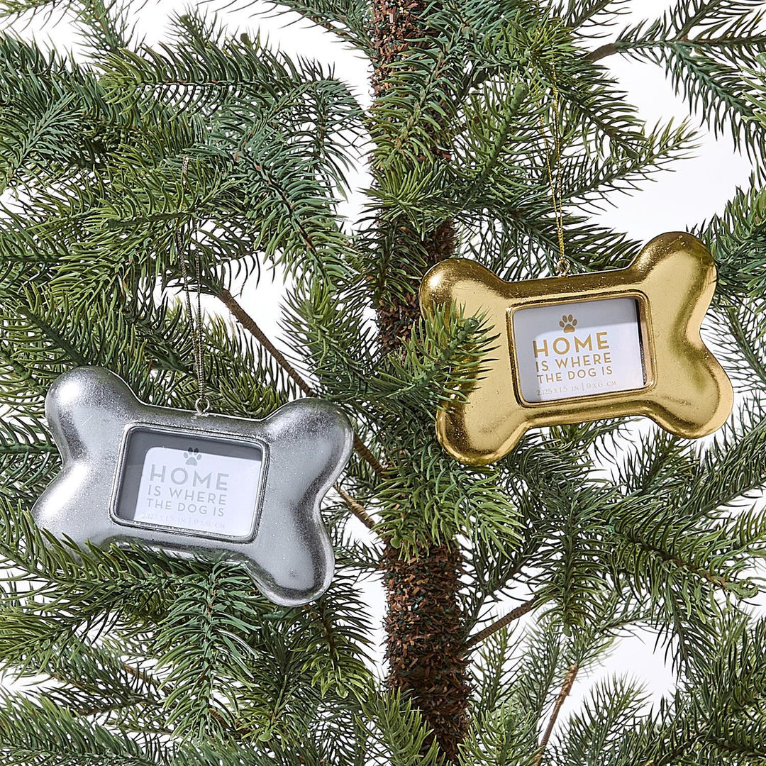 Silver and gold Dog Bone Photo Ornaments engraved with a paw print and “Home is where the dog is.”.