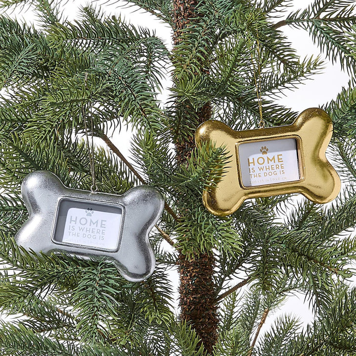 Silver and gold Dog Bone Photo Ornaments engraved with a paw print and “Home is where the dog is.”.