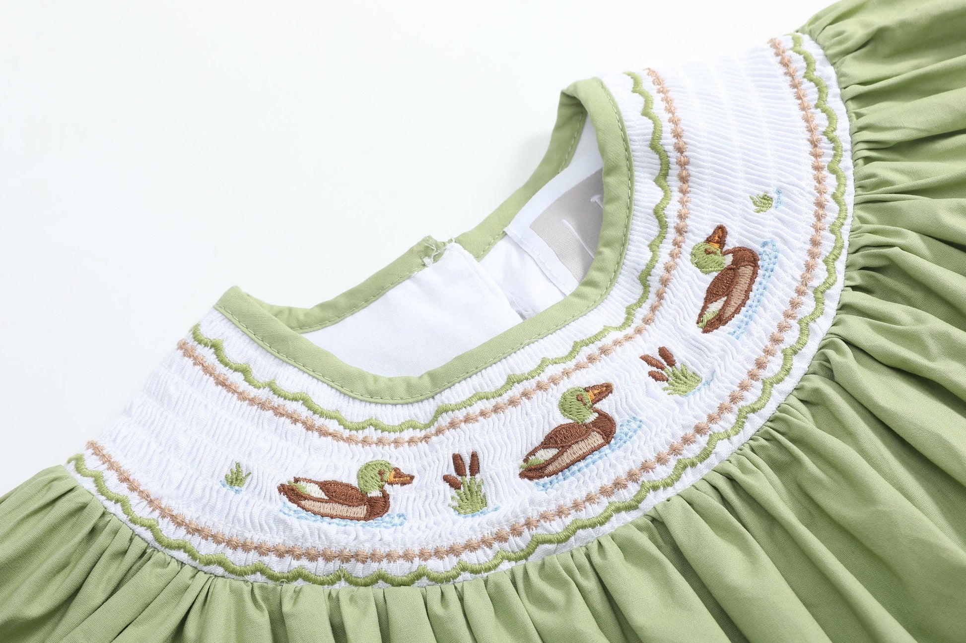 Pistachio Green Mallard Duck Smocked Bishop Dress in size 4T, featuring green fabric and a white smocked collar embroidered with ducks, cattails, and grass in brown, green, and blue thread.