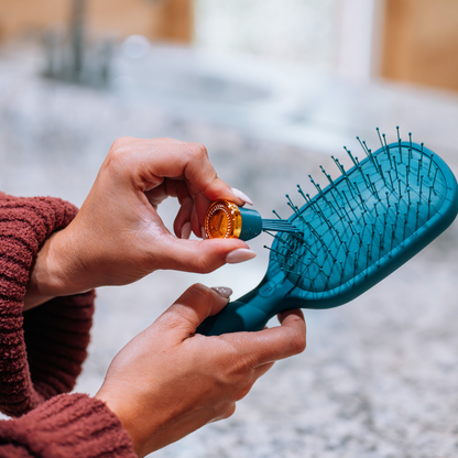Detangler Hair Brush for Medium Hair - Teal With It shown with oil applied to bristles; available in multiple sizes.