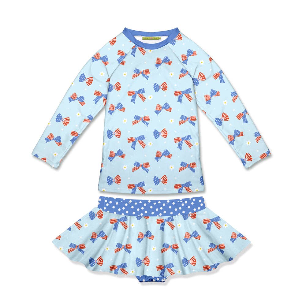 Light blue long-sleeve rashguard with patriotic bows, matching skirt, blue polka-dot waistband. Size: 2T.