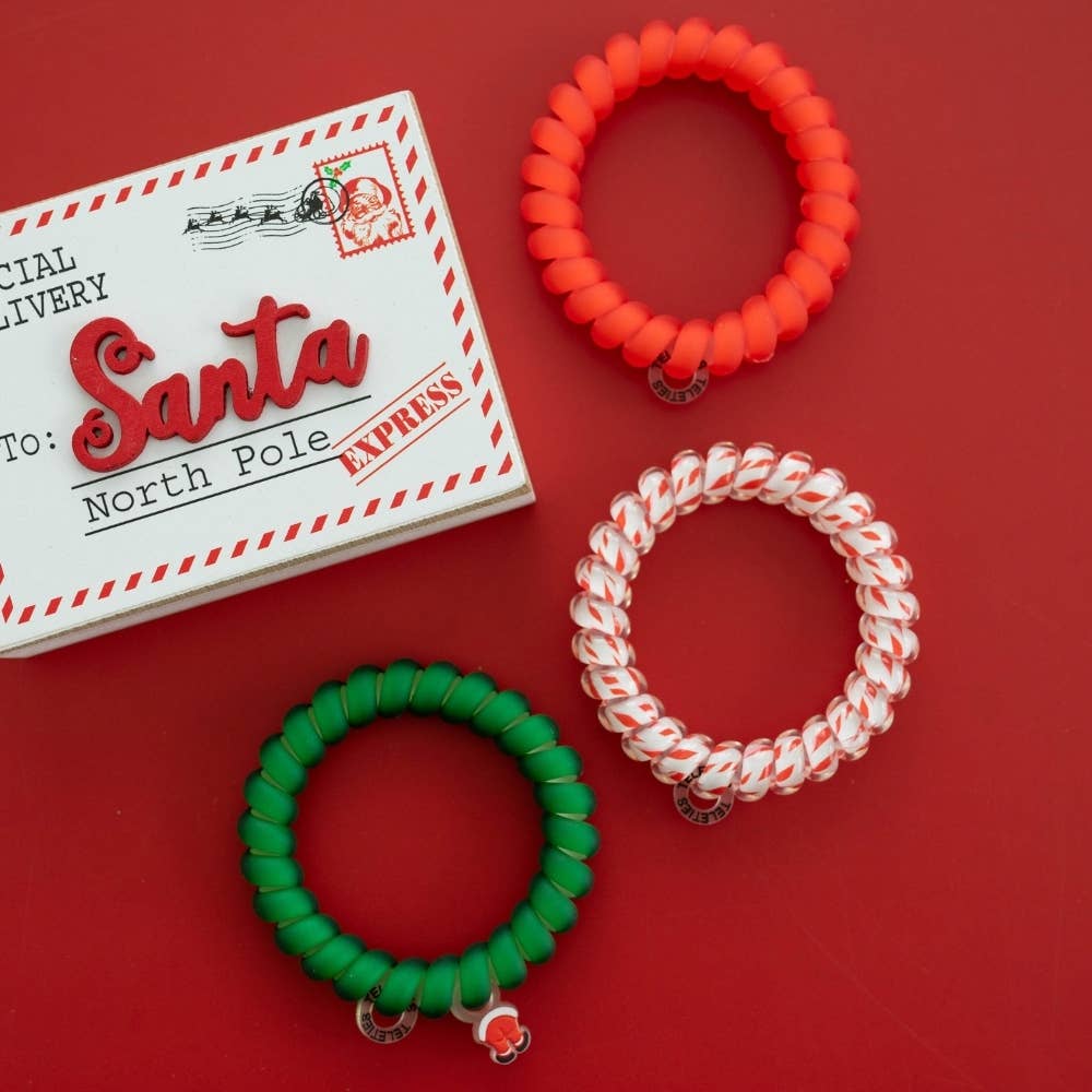 Claus I said So | Large | Hair Ties: three Santa-inspired spiral coil hair ties in red, green, and a white-and-red twist pattern.
