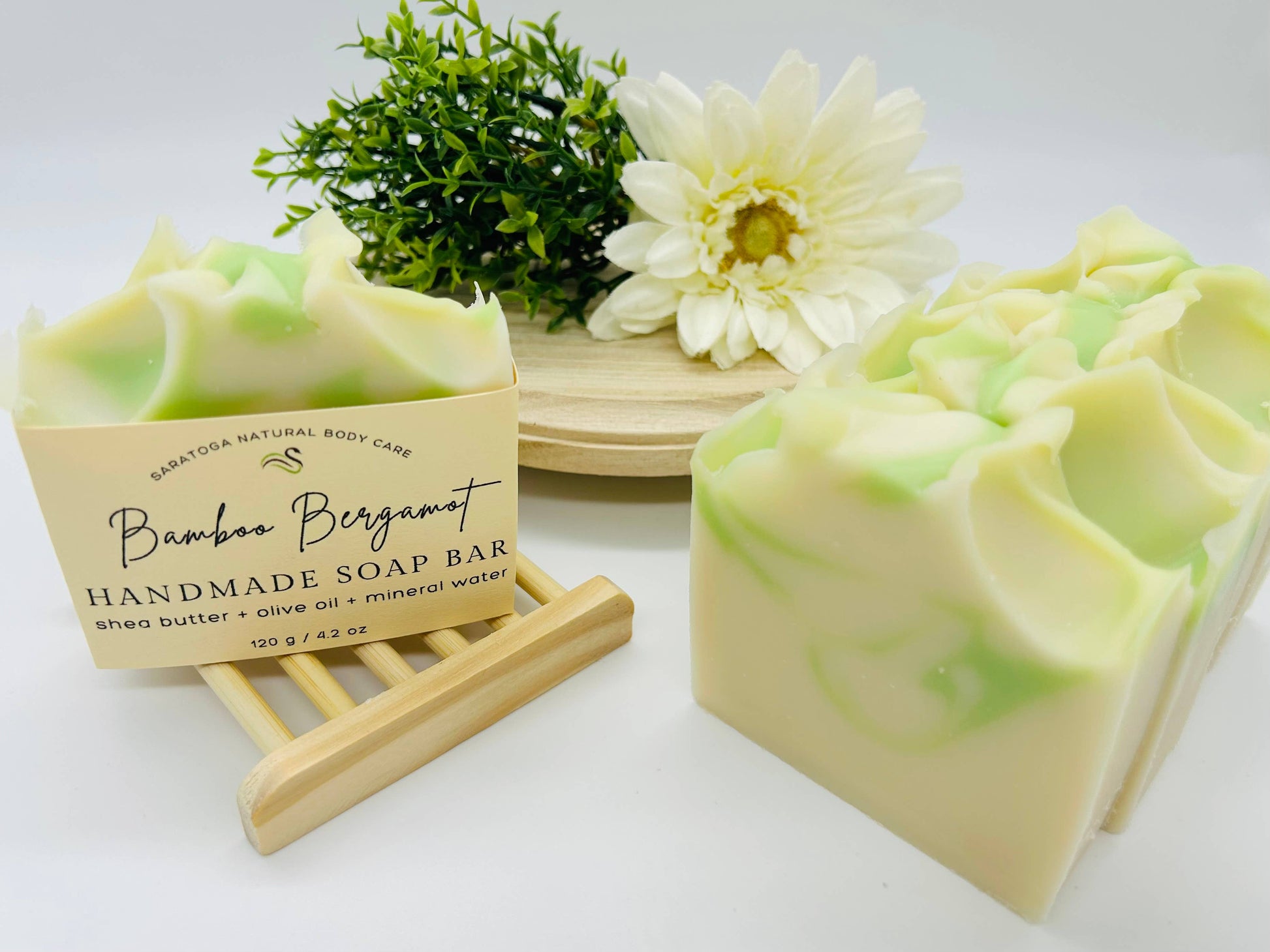 The product is a set of two Bamboo Bergamot Handmade Soap Bars. These vegan and cold process bars feature appealing green swirls on top. No additional sizes available.