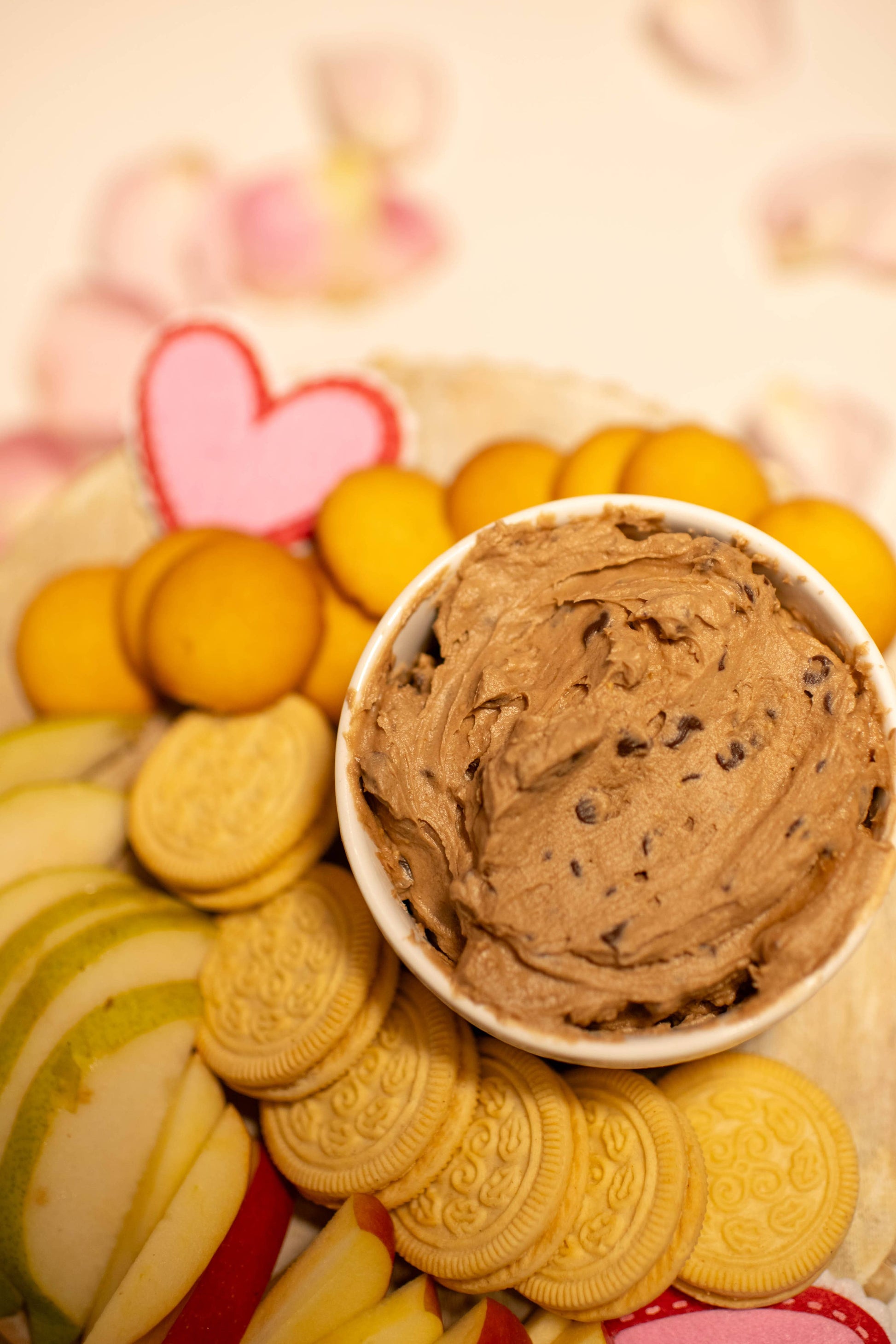 Chocolate Chip Cookiedough Cheesecake Dip in a bowl with cookie crumbles. Sizes: small, medium, large.