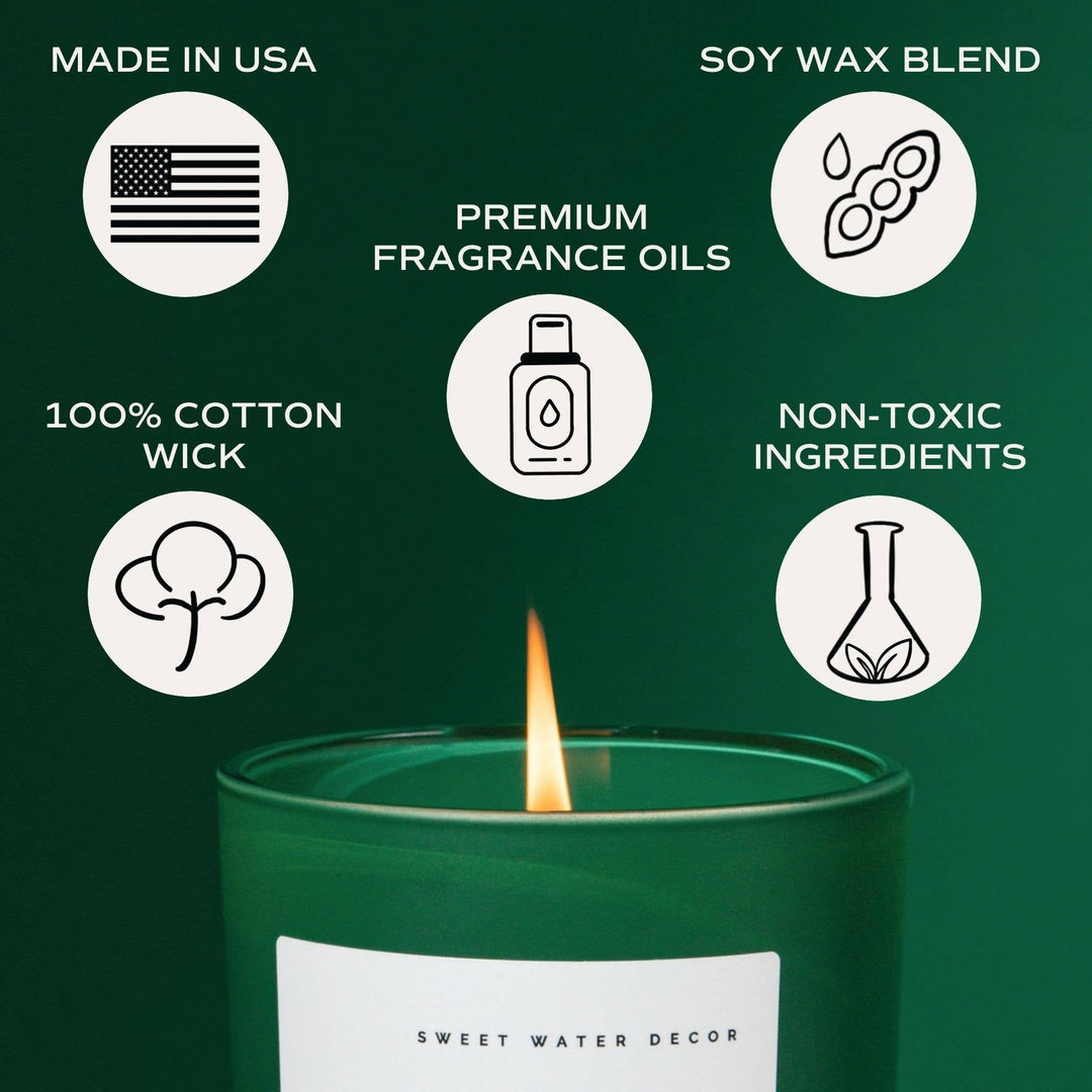 Green 15 oz Under the Mistletoe soy matte candle with a lit flame, featuring US-made origin, premium fragrance oils, cotton wick, and non-toxic ingredients.