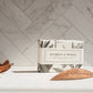 The product is a box of Bourbon & Vanilla Soap - Bath Bar. It evokes a natural vibe. The soap is available in bar size only.