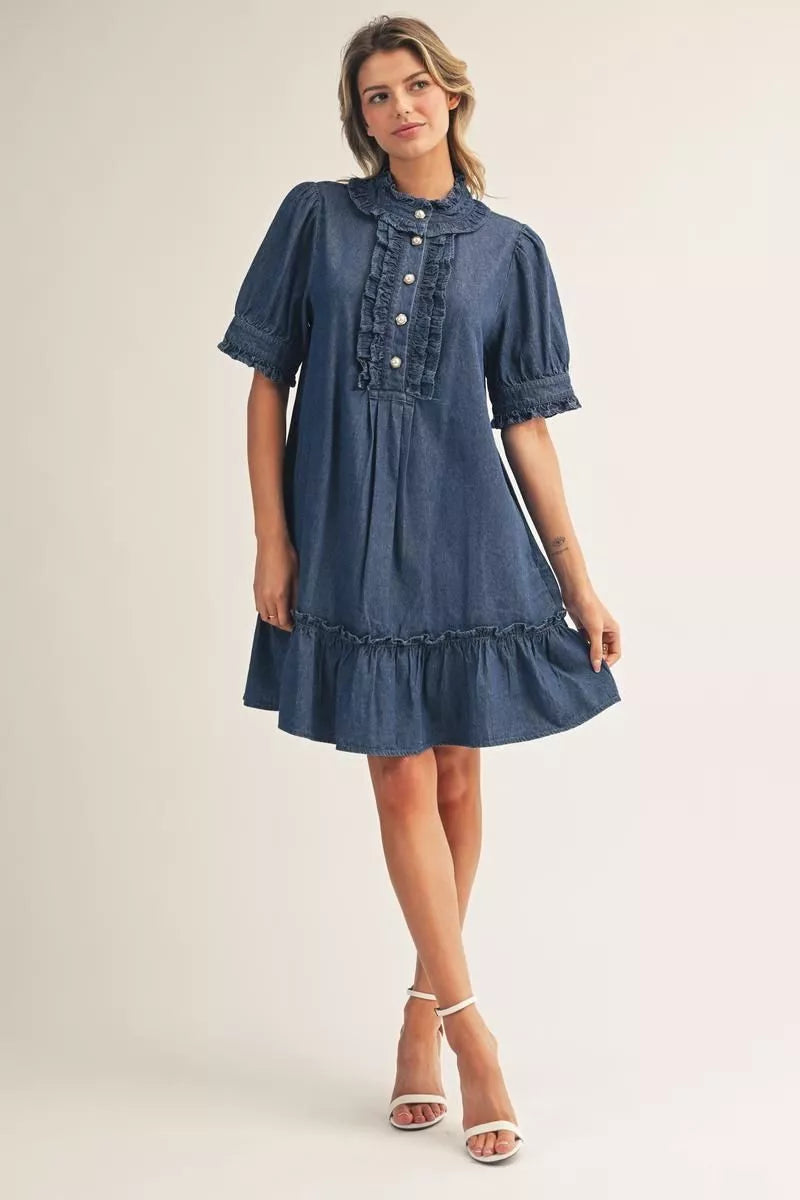 Darcy Ruffle Denim Dress in blue with a ruffle-trimmed collar, button front, puffed sleeves, and ruffled hem.