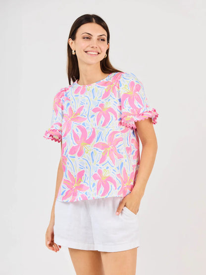 Cassidy Hibiscus Harmony White Top: floral, short sleeves, ruffled cuffs, crew neck. Available in sizes XS–XL.