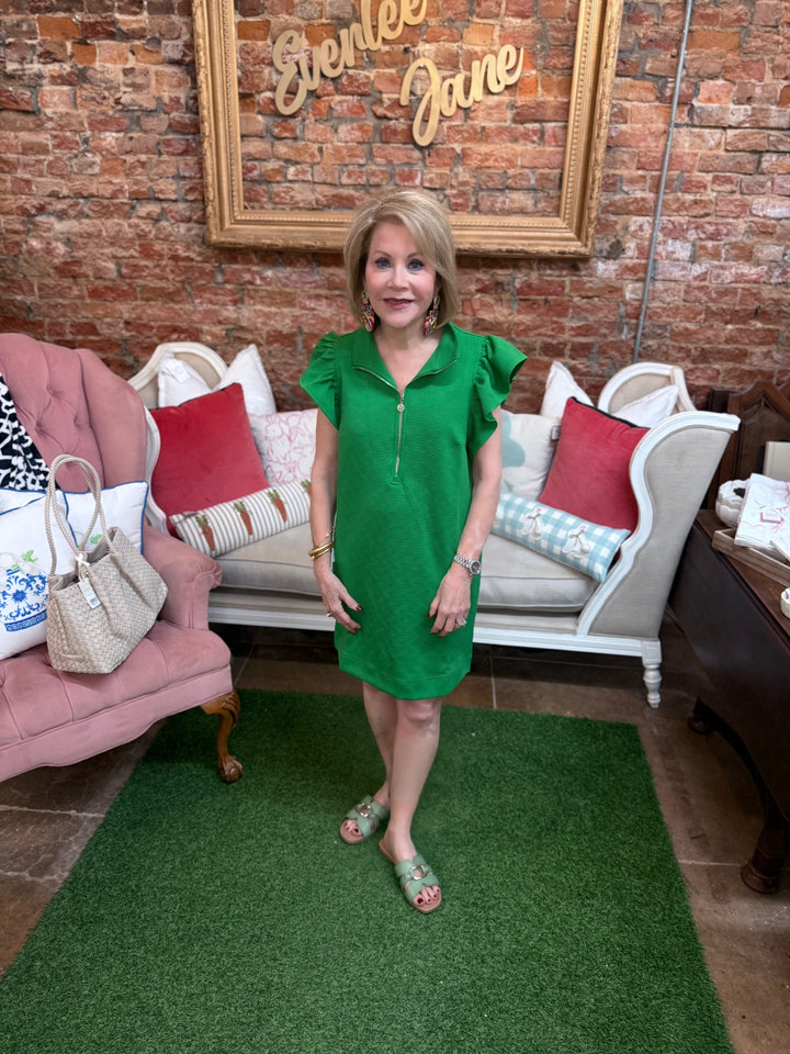 Paige Green Dress with flutter sleeves and gold zipper. Available in sizes XS-XL.