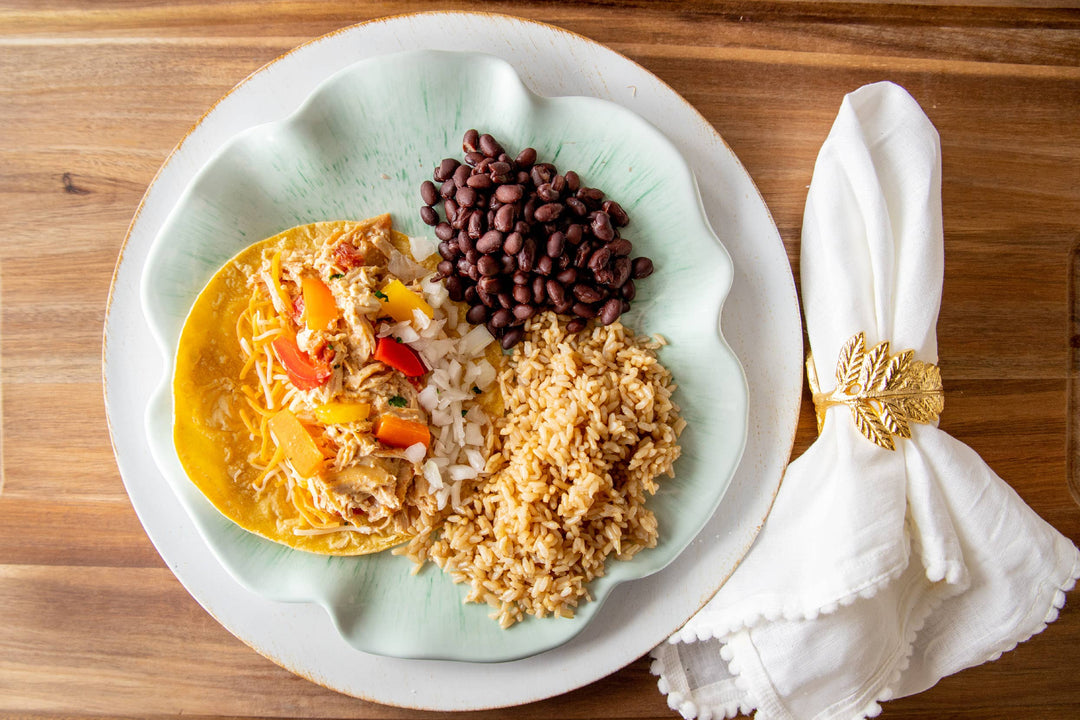 Tex Mex Chicken Fajitas with shredded chicken, vegetables, black beans, and brown rice on a plate. Available in 2 sizes.