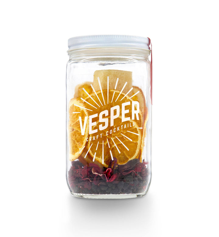 32 oz glass jar cocktail kit with dried orange slices, red petals, white lid, red tag, labeled "Vesper Craft Cocktails".