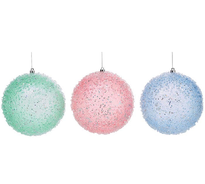 Large glittered plastic ornaments in mint green, light pink, and light blue with textured, iridescent finishes.