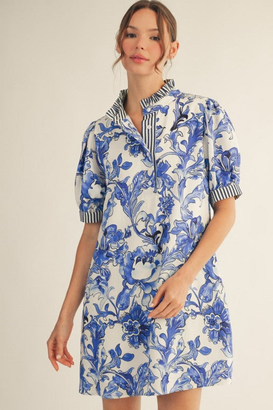 Royal Blue Floral Dress: short, loose fit, blue florals, ruffled neckline, striped collar/cuffs, side pockets. Sizes XS-XL.