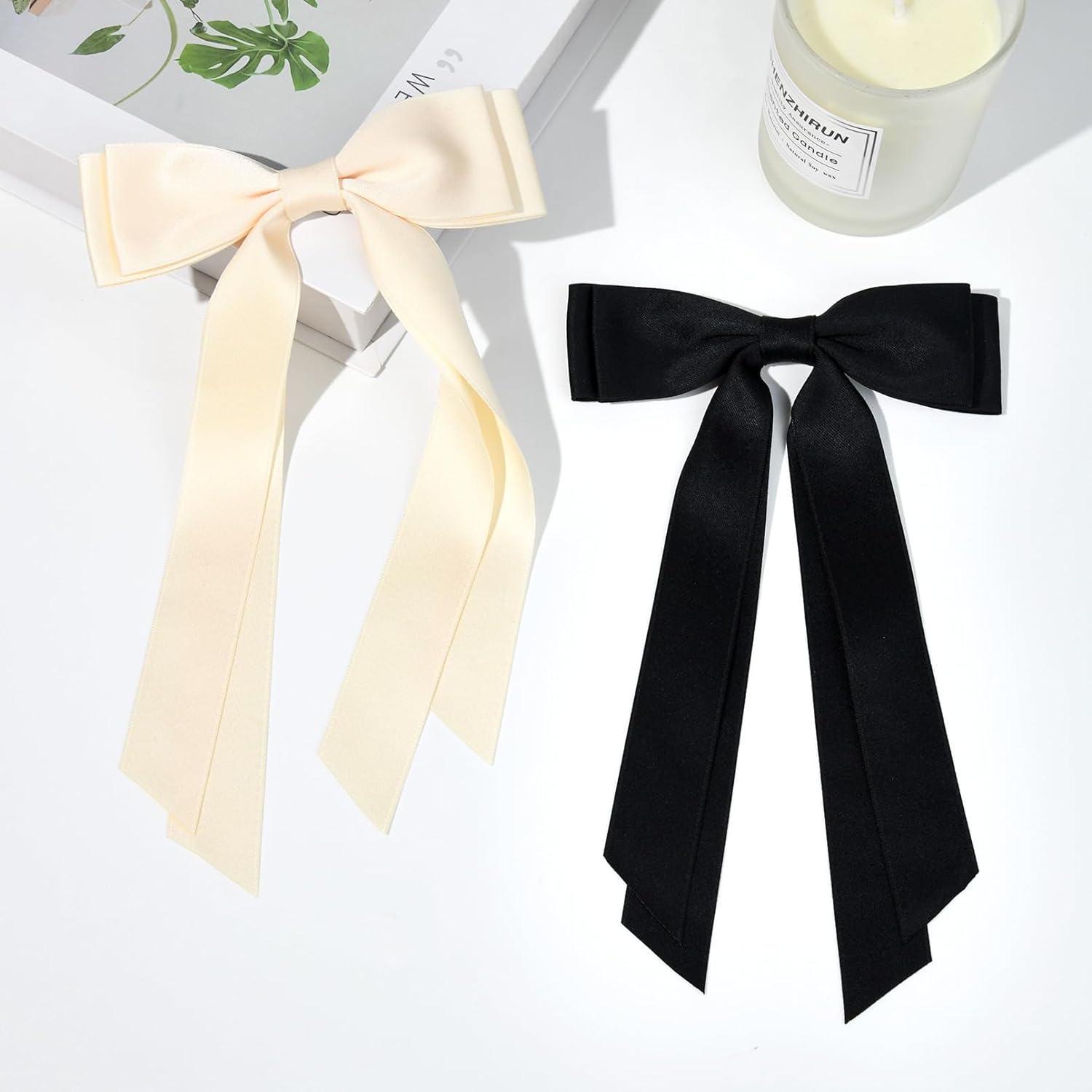 Two oversize satin hair bows with trailing ribbons. Available in black and white. Ideal gift for any occasion.