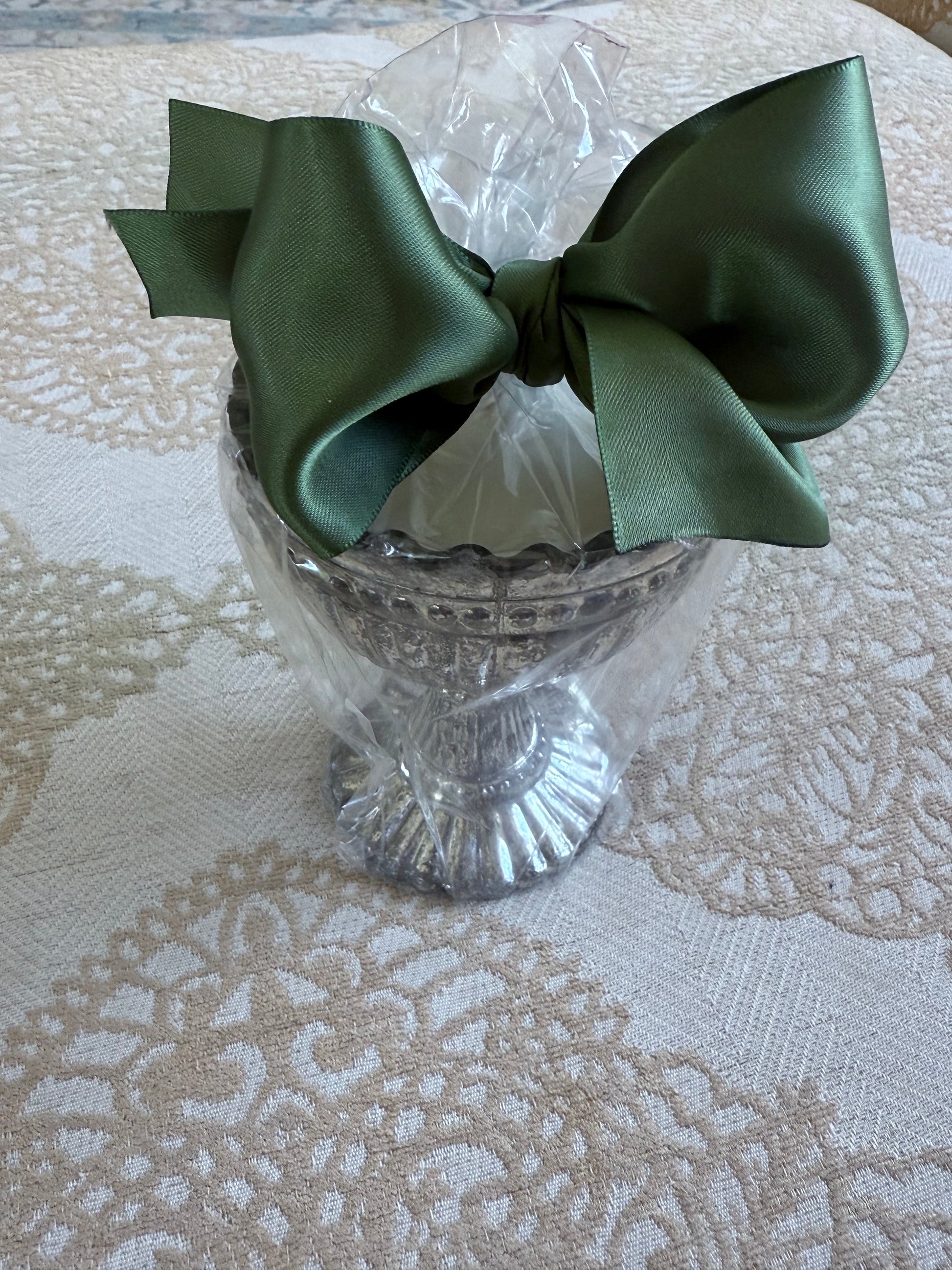 French Bee Candle in silver antique vessel, wrapped in clear plastic with green satin bow. Available in 4oz, 8oz, and 12oz sizes.