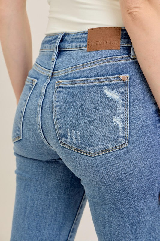 Judy Blue Vintage Wash Boot Cut Jeans in light blue distressed denim, brown waistband label, back pocket. Sizes: 0-24.