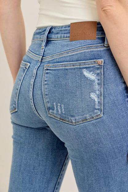 Judy Blue Vintage Wash Boot Cut Jeans in light blue distressed denim, brown waistband label, back pocket. Sizes: 0-24.