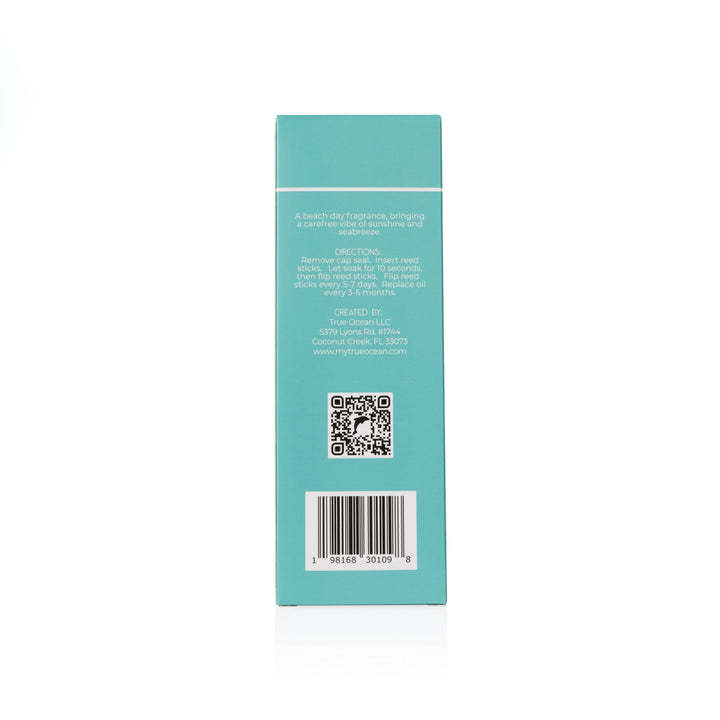 Back of turquoise True Ocean Reed Diffuser box, white text, QR code, barcode. Coastal scent. Sizes: not specified.