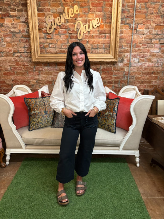 Off-White Ruffle Collar Button-Up Blouse. Available in sizes XS–XL. Features ruffle collar and front buttons.