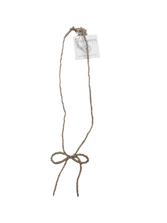 Delicate gold chain necklace with a bow-shaped pendant and gold/silver beads. Available sizes: 16", 18".