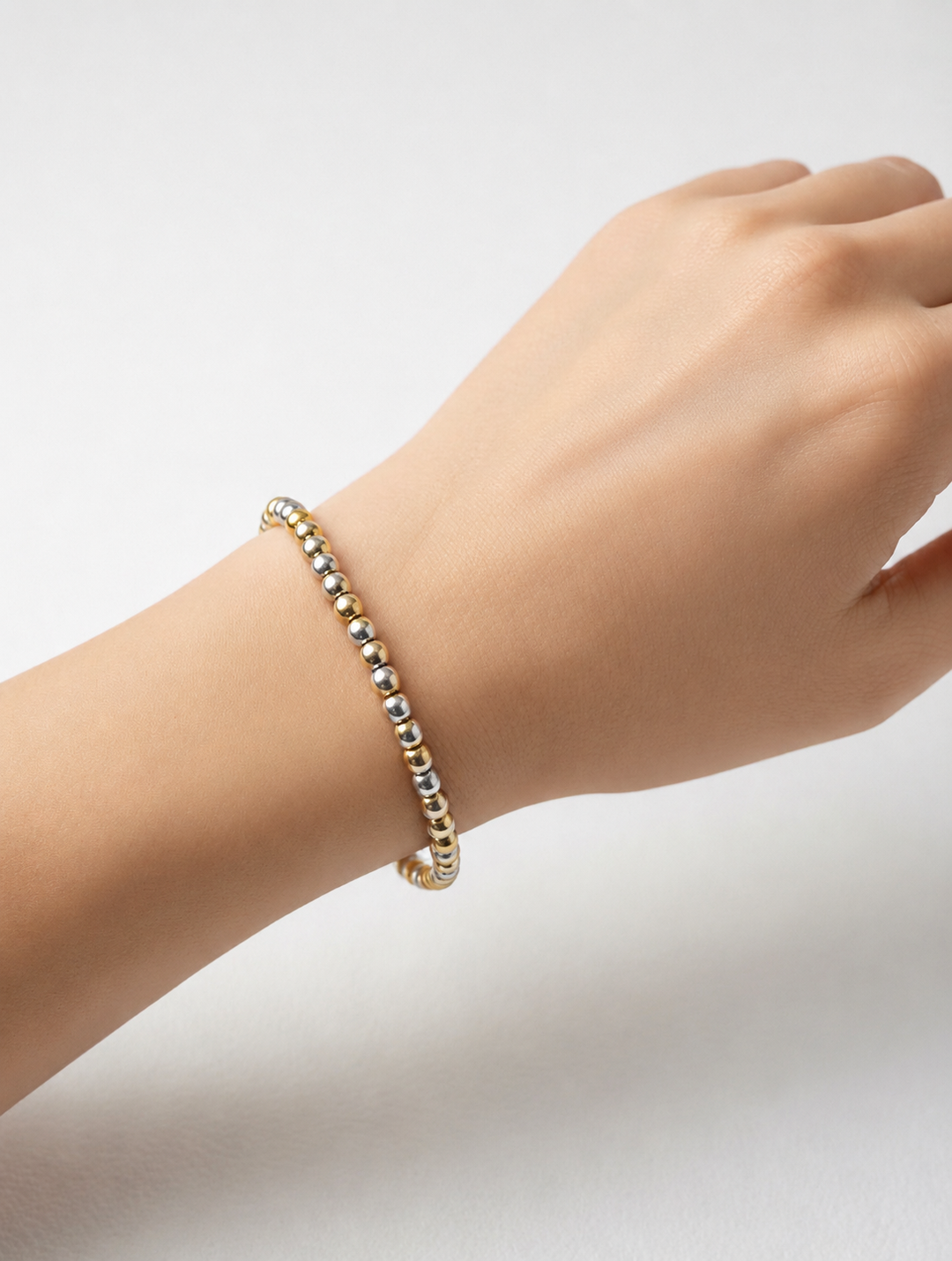 Water Resistant Beaded Stretch Bracelet with alternating gold and silver beads. Available in S, M, and L sizes.
