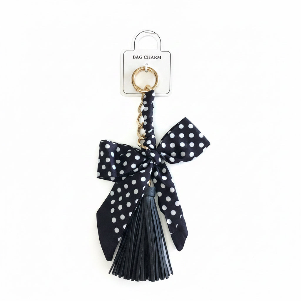 Black and white polka dot ribbon bow on a gold keyring with a black tassel. Available in small and medium sizes.