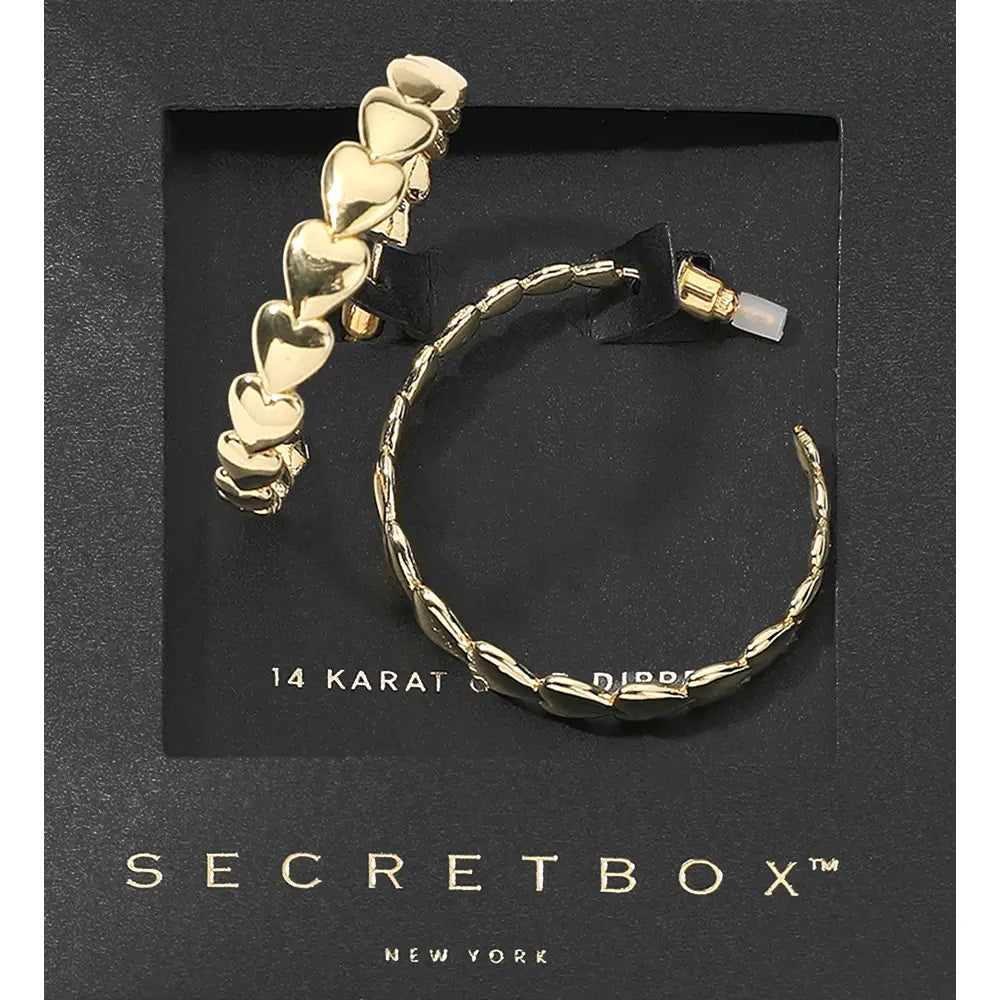 The Secret Box 14K Gold Dipped Heart Hoop Earrings feature a heart-themed design with a post back. Available in one size. Packaged in black Secretbox packaging.