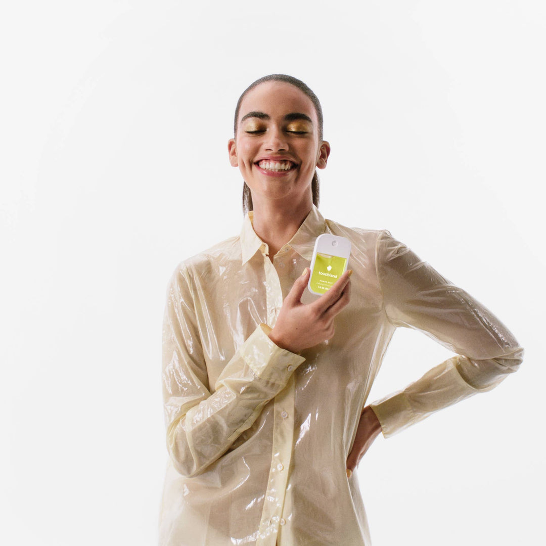 Slim, rectangular Vanilla Blossom Power Mist Hydrating Hand Sanitizer spray bottle with green label.