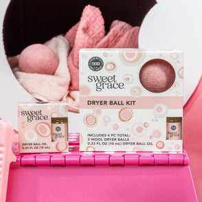Pink wool Dryer Ball Kits Sweet Grace with fragrant laundry oil; available in standard and large sizes.