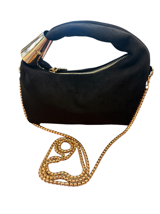 Modern black suede crossbody with gold zipper, thick curved handle, and detachable gold chain strap. Sizes: Small, Medium.