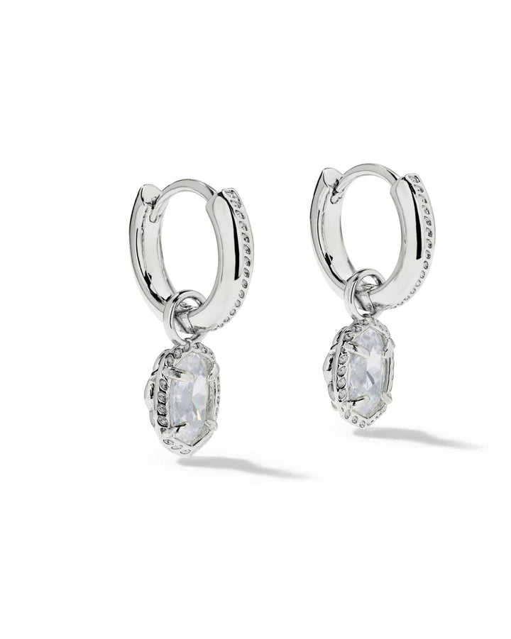 Silver Mini Ella Luxe Huggie CZ Earrings with oval-cut white stone drops and clear stone accents.
