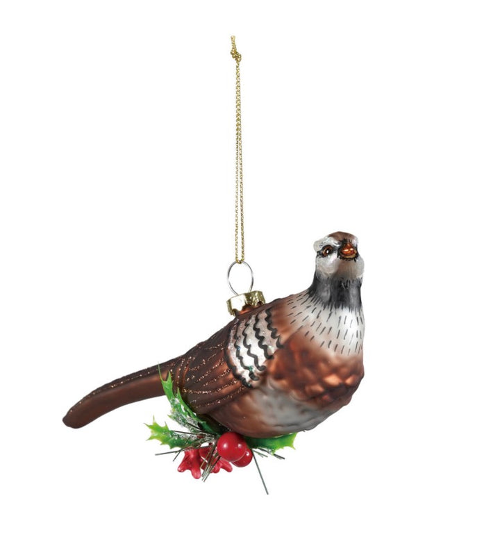 Glass pheasant ornament with holly and berries on a gold cord.