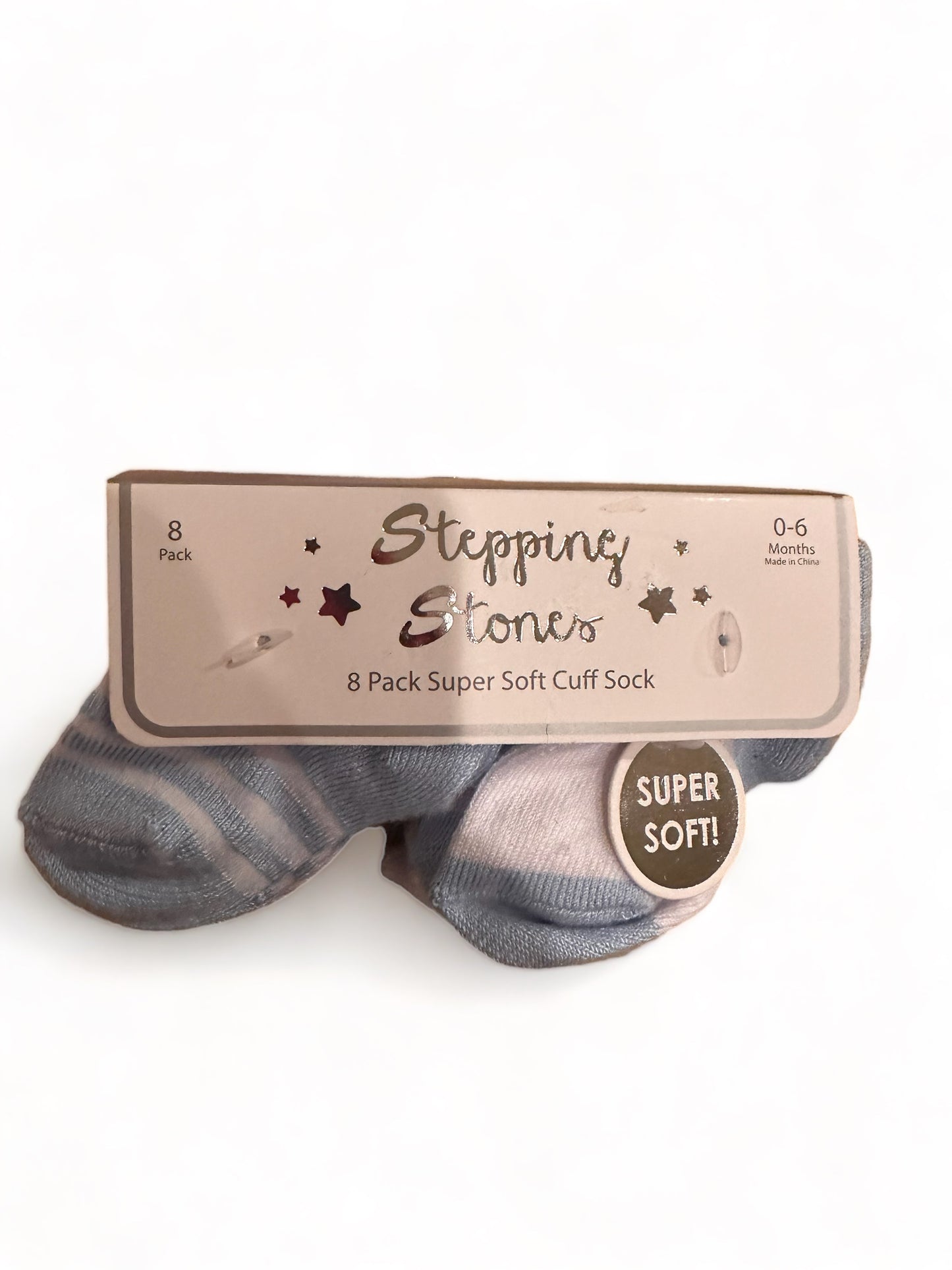 A package of eight stepping stones brand infant socks for 0-6 months, labeled as "super soft cuff sock" and "super soft!" on a beige background.