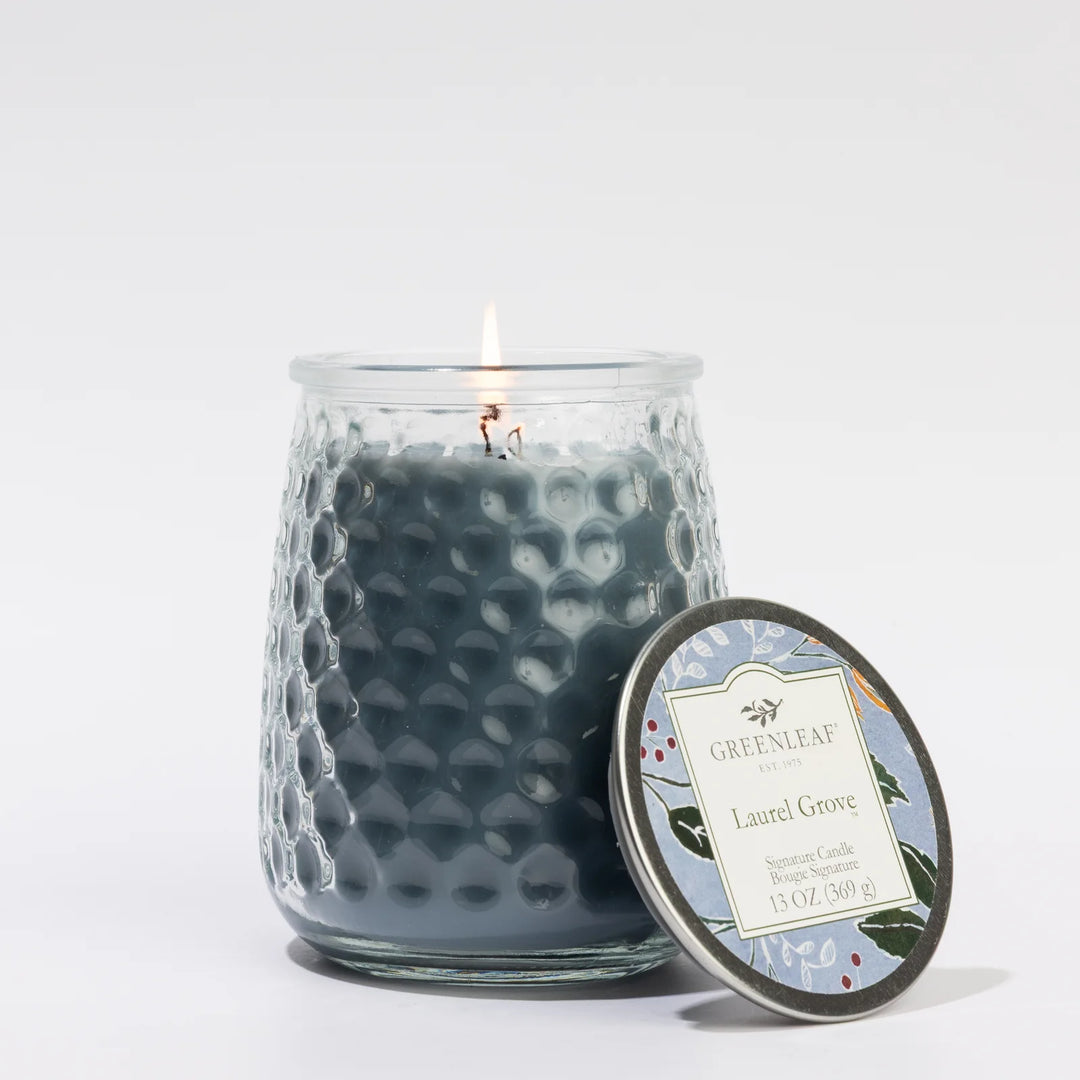 Laurel Grove 13oz Candle in textured dark blue glass with floral-labeled lid; available in 13oz size.