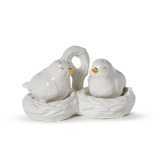 White ceramic bird salt and pepper shakers with gold details in a nest carrier with handle. Sizes: standard only.