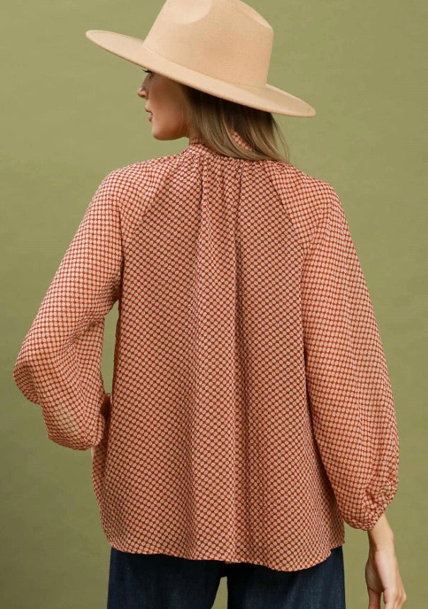 Dottie Tie Top: long-sleeve orange polka dot shirt, available in sizes XS–XL.