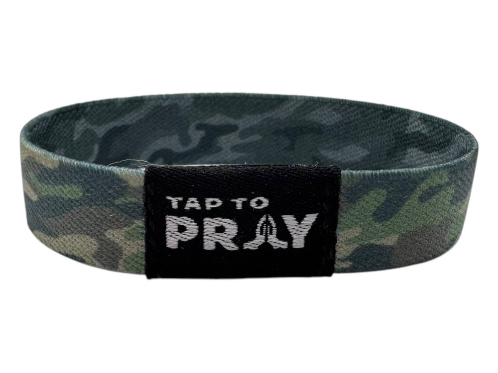 Green & charcoal camo wristband with black patch, white "TAP TO PRAY" text; available in multiple sizes.