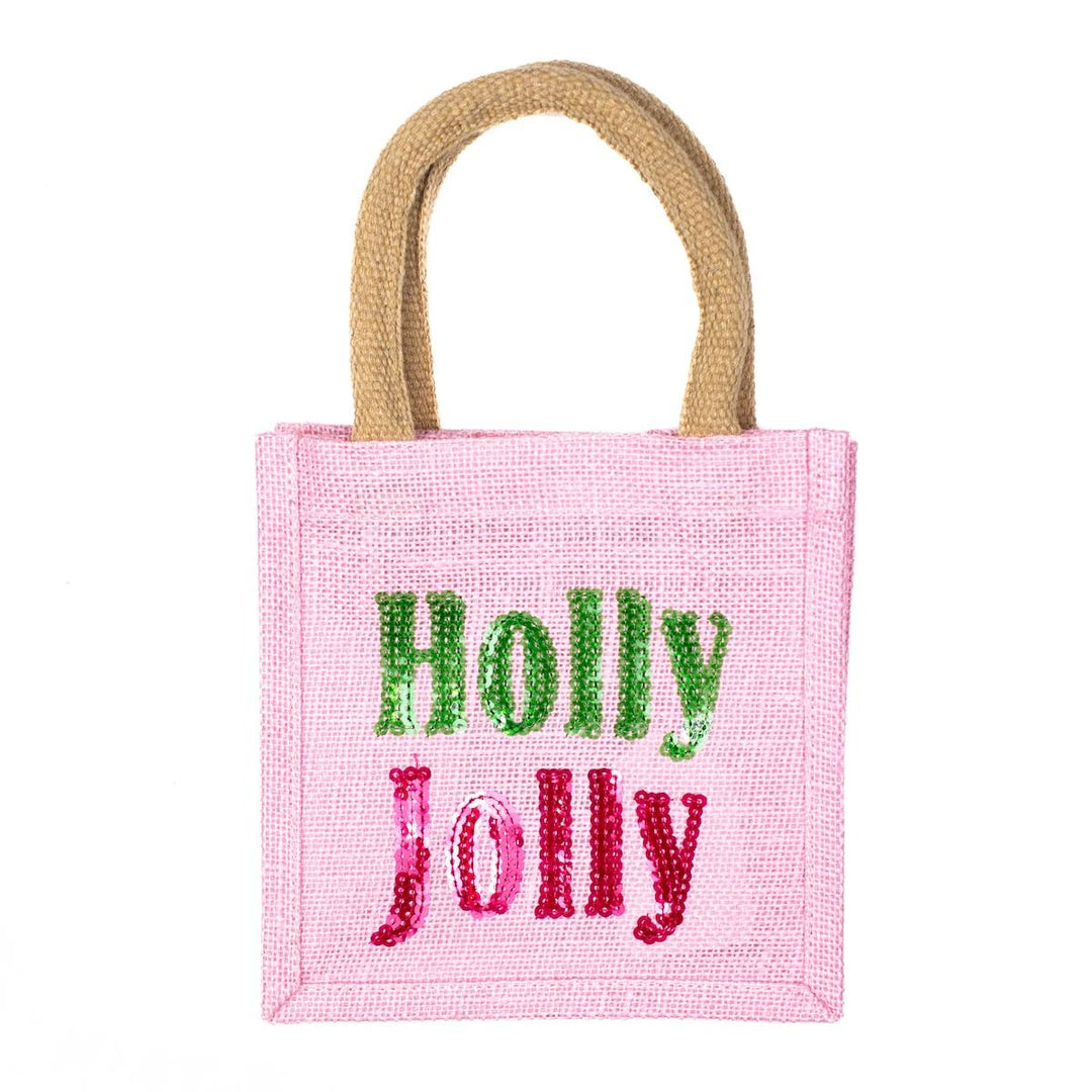 Holly Jolly Petite Tote in pink textured fabric with two top handles, featuring “Holly” in green sequins and “Jolly” in pink sequins.