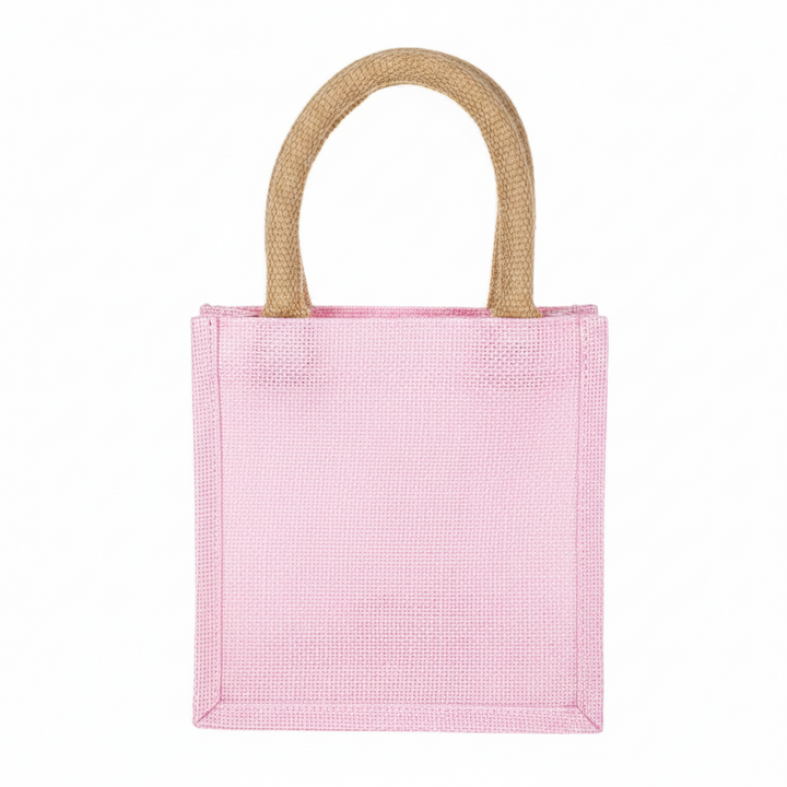 Small, square, pink Holly Jolly Petite Tote with two rounded tan handles.