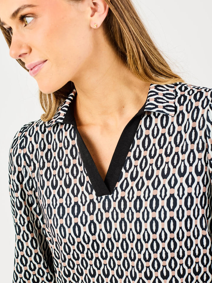 Raelyn High Notes Tan Dress: black/white geometric pattern, black-trimmed V-neck, relaxed fit. Sizes: XS–XL.
